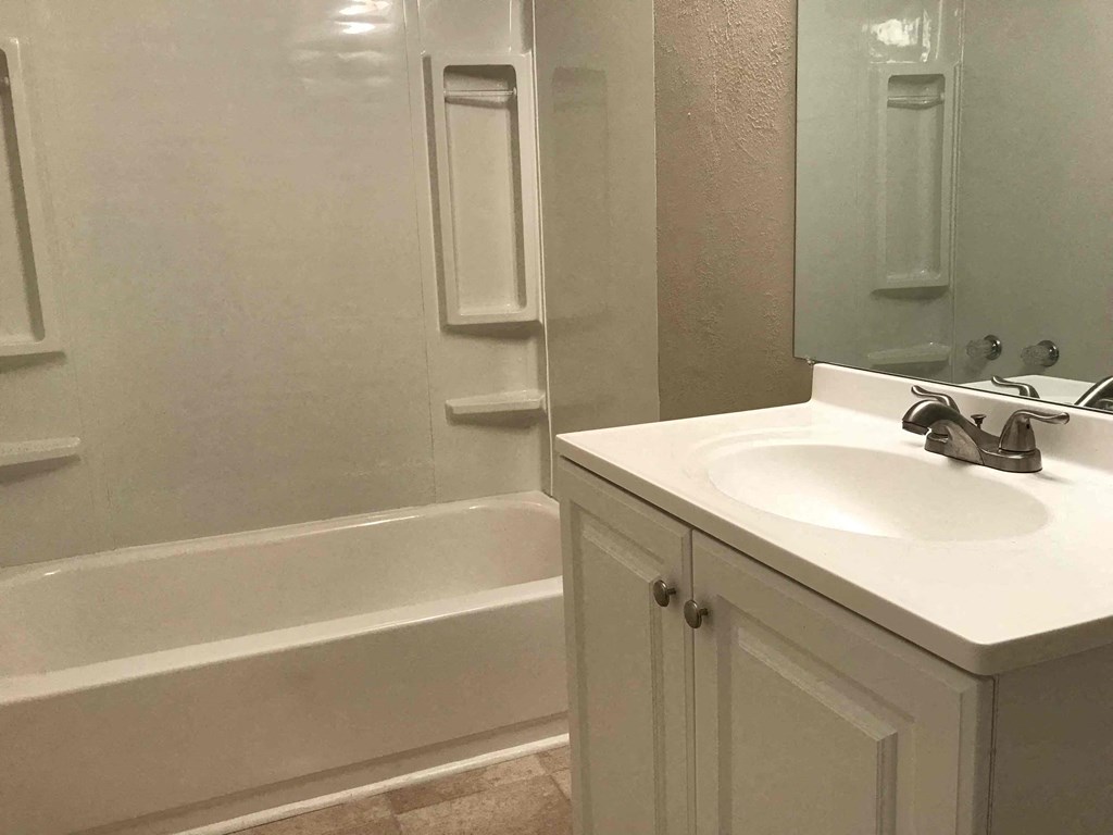 a bathroom with a sink and a bath tub