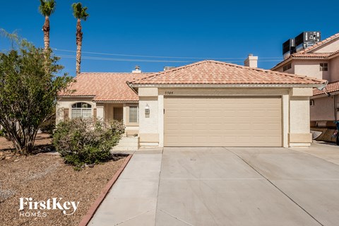 a clean driveway and a garage door in front of a house