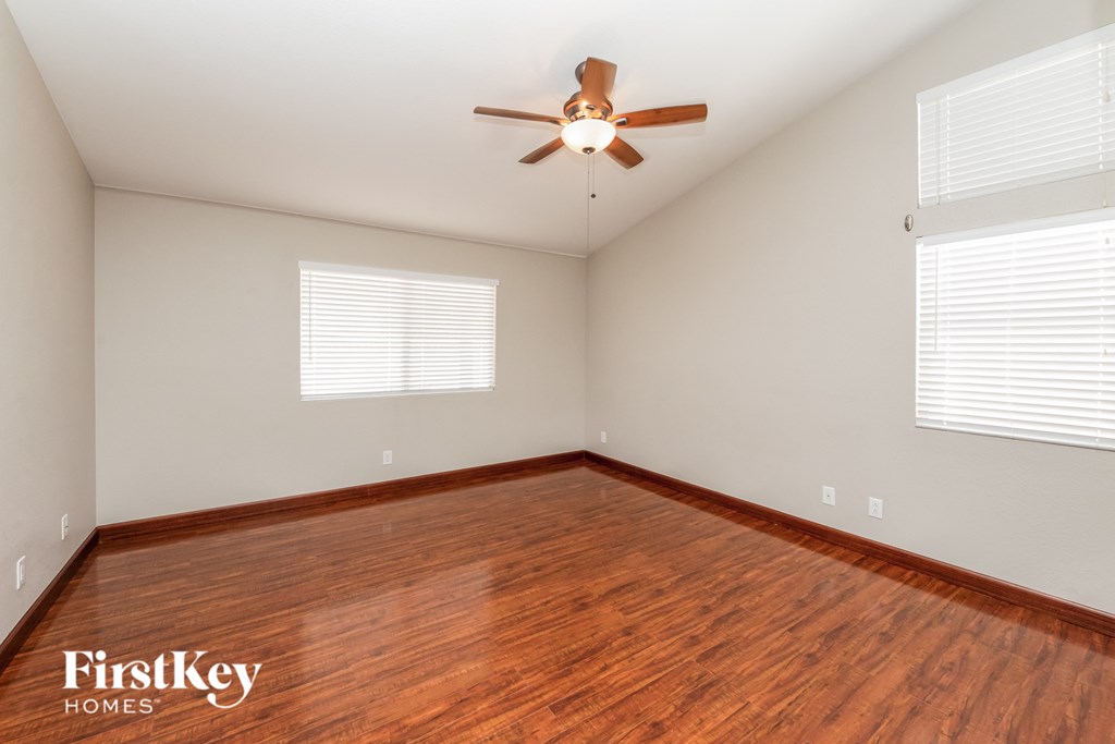 the living room with hardwood floors and a ceiling fan