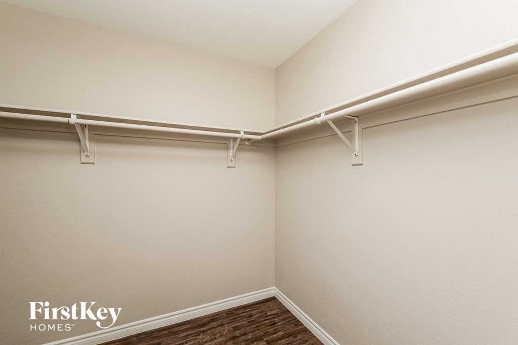 a large white room with a white wall and a long white pipe hanging from it