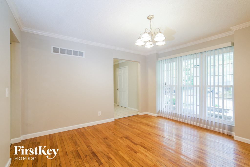 the living room and dining room with wood flooring and large windows