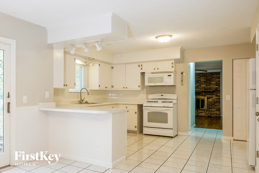a kitchen with white cabinets and a white counter top