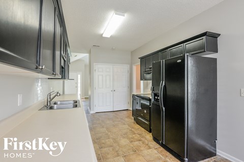a kitchen with black appliances and a white counter top