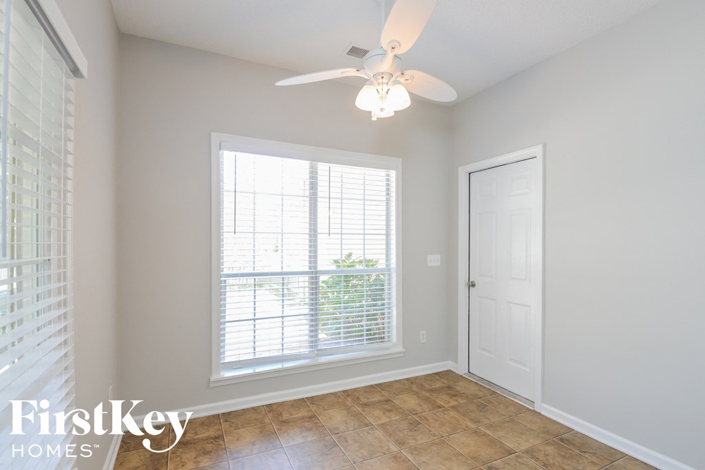 a living room with a ceiling fan and a window