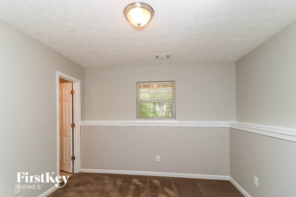 a empty room with a door and a window