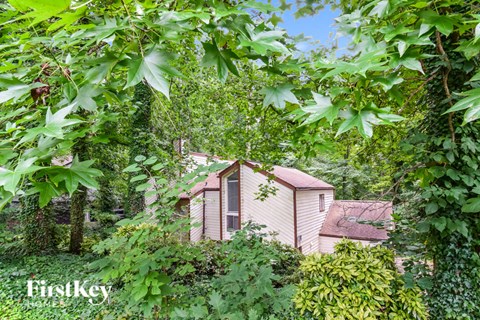 a small house in the woods surrounded by trees