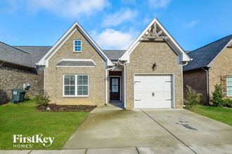 updated brick home with a white garage door