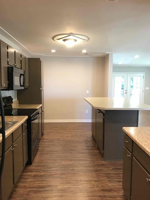 A kitchen with brown cabinets and a counter top.