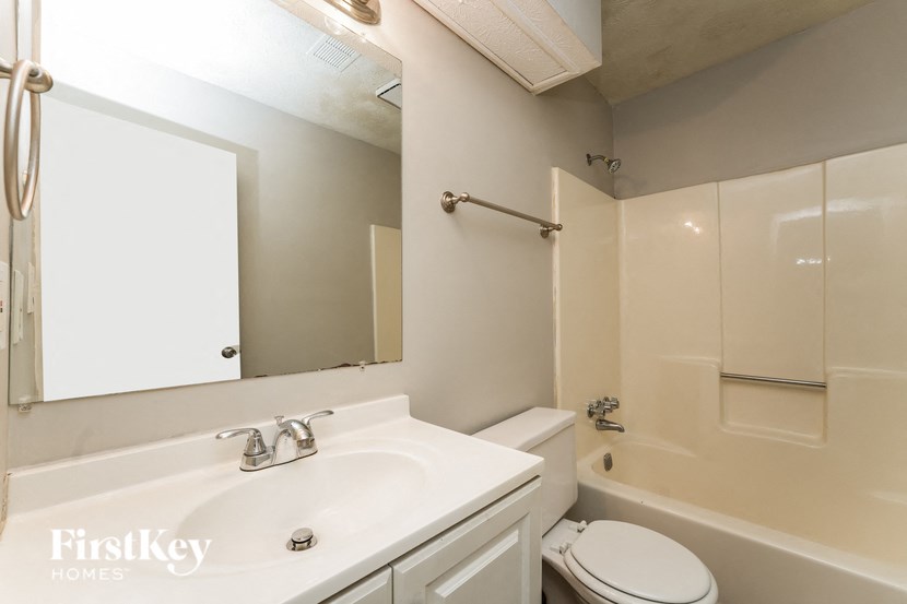 a bathroom with a white sink and a toilet and a tub