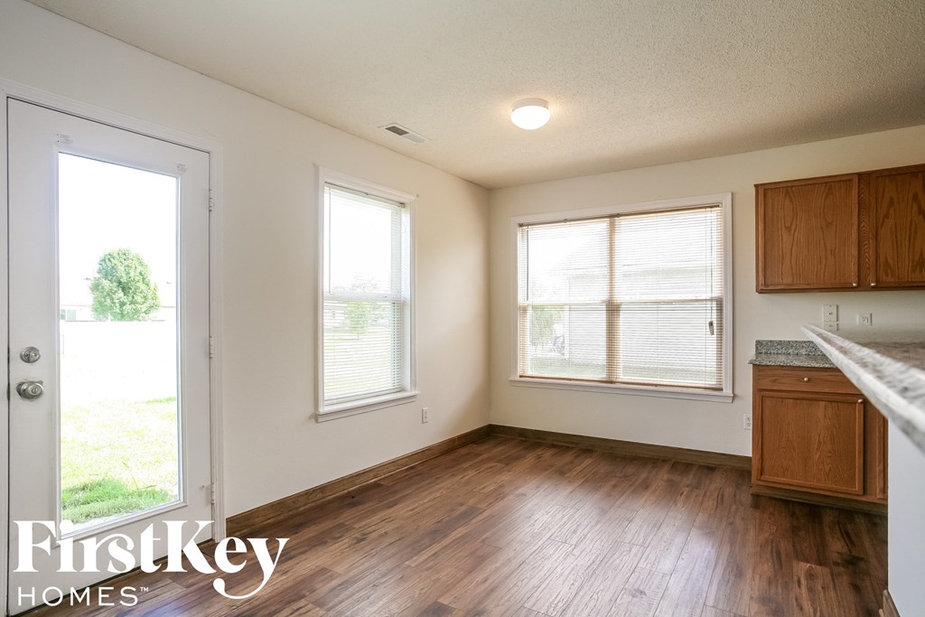 A room with wooden floors and a white door.