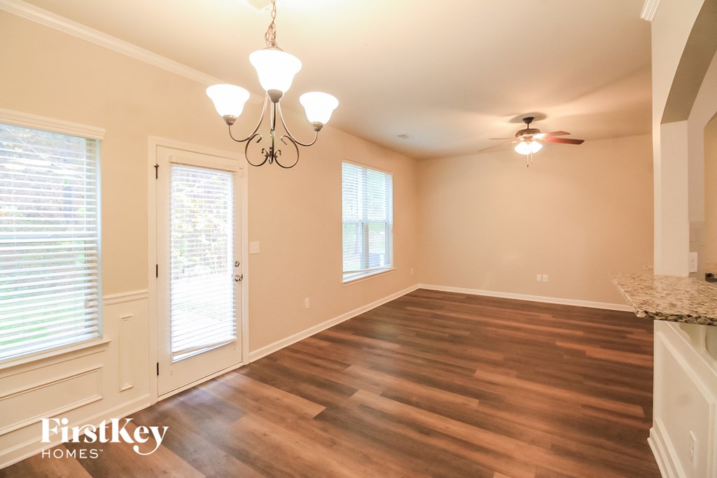 the dining room after remodeling with wood flooring and a chandelier