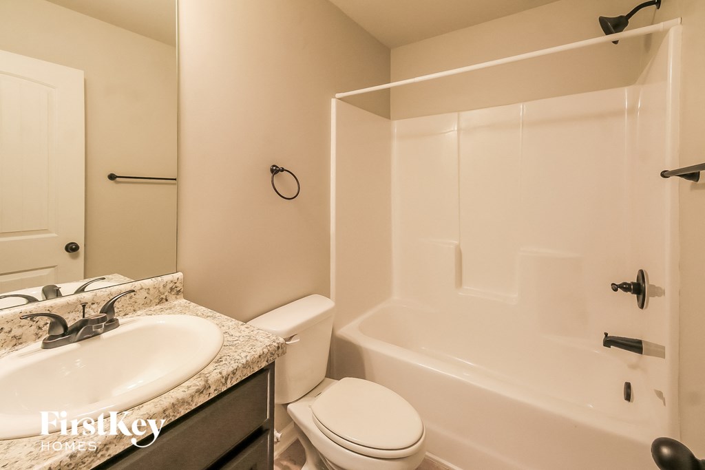 a bathroom with a sink and a toilet and a tub