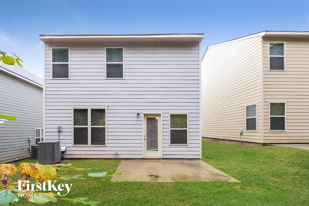 a white house with a yard in front of it