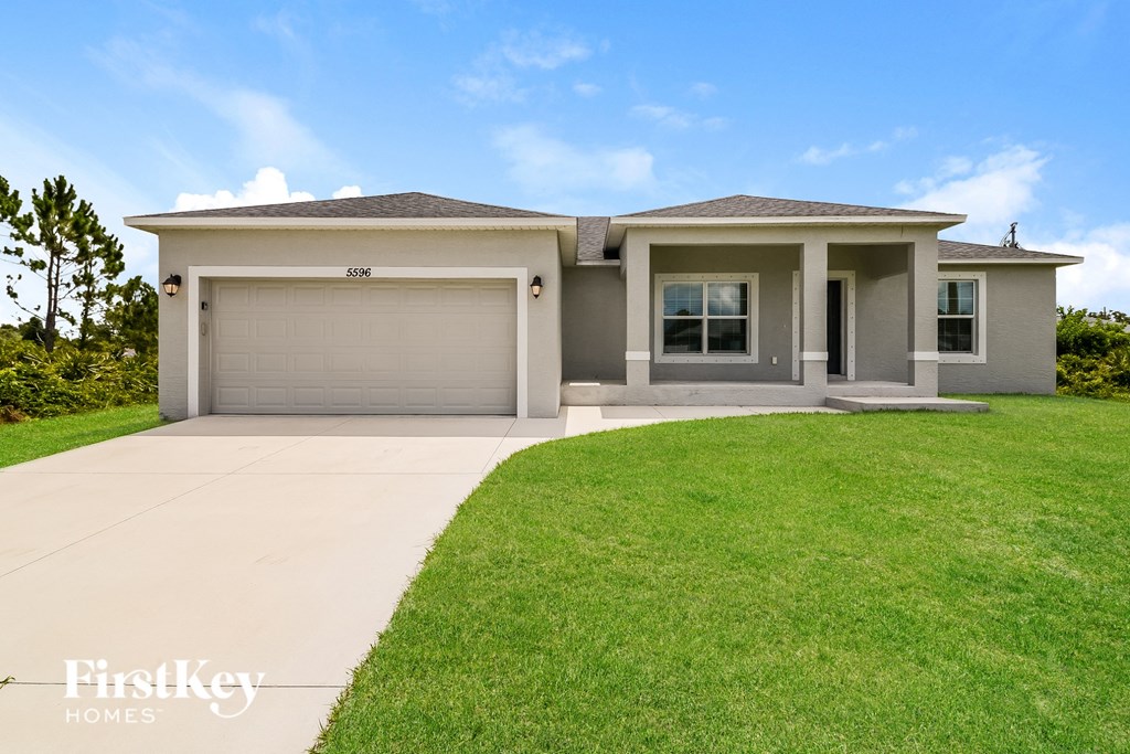a house with a lawn and a driveway