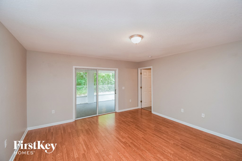 a living room with wood flooring and a sliding glass door