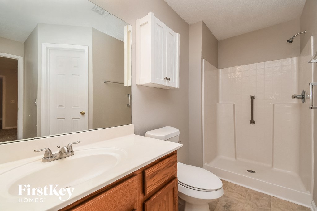 a bathroom with a sink toilet and a shower