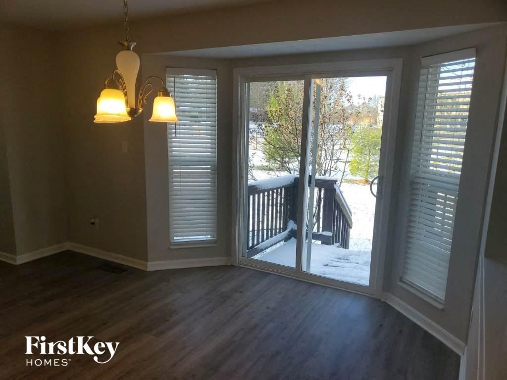 A room with a view of a deck through a sliding glass door.