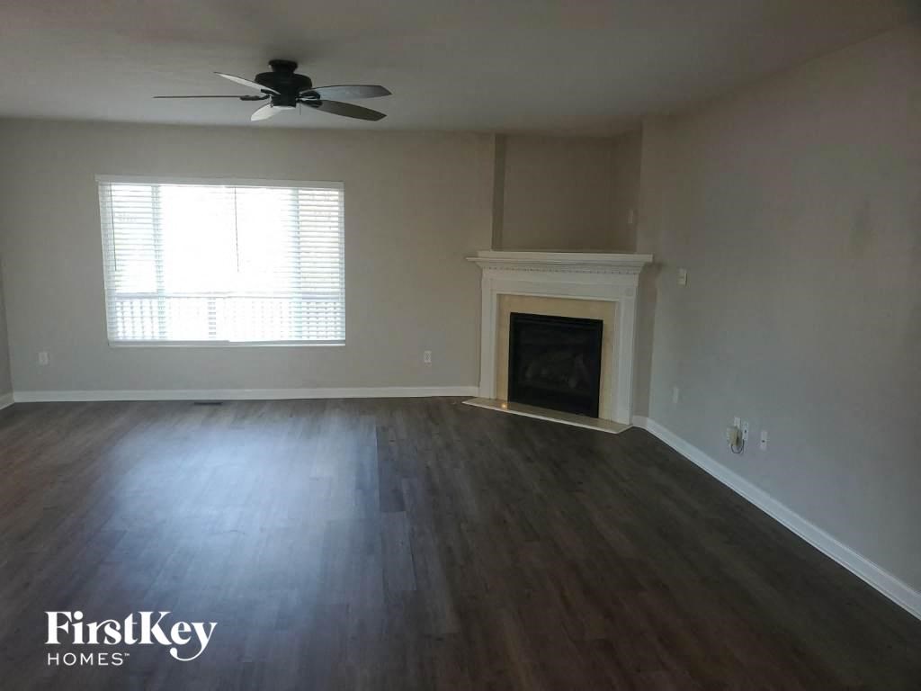 A room with a fireplace and a ceiling fan.