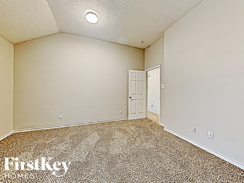the living room is spacious and has a door to the hallway