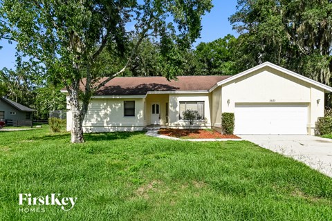 a white house with a yard and a garage