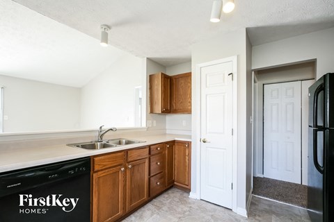 A kitchen with a sink and a dishwasher.