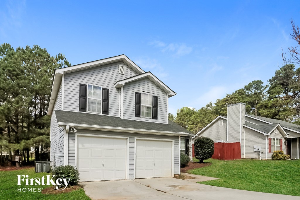 a gray house with a white garage door