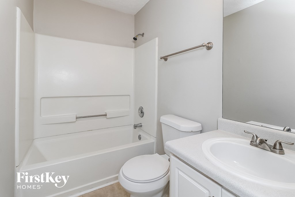 a bathroom with a sink toilet and a bath tub