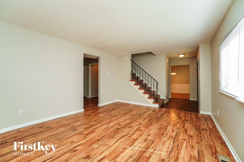 the living room and dining room with hardwood flooring