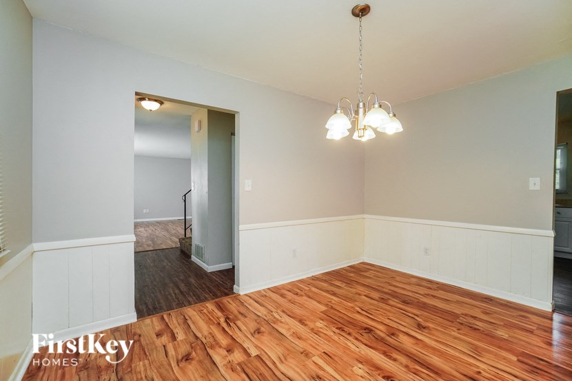 a renovated living room with wood flooring and white walls