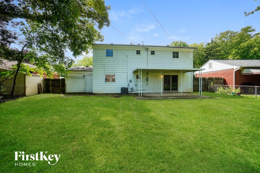 a white house with a yard in front of it