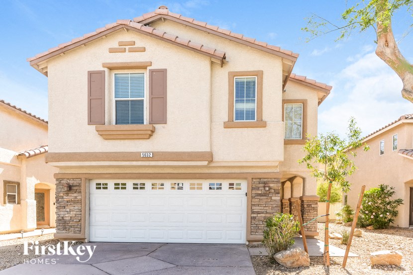 a house with a white garage door in front of it