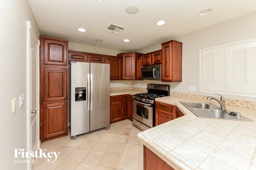 a kitchen with wooden cabinets and stainless steel appliances