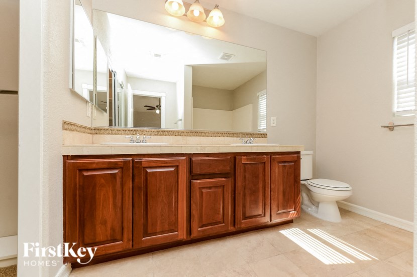 a bathroom with a toilet and a sink and a mirror