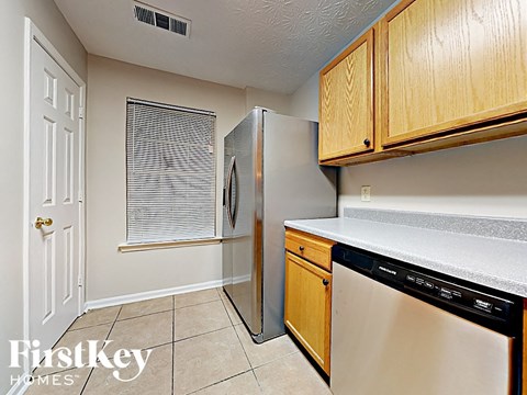 a kitchen with a refrigerator and a dishwasher