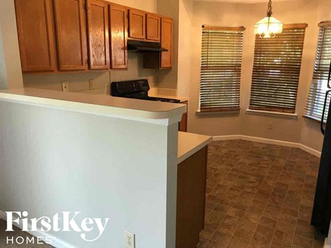 A kitchen with wooden cabinets and a white countertop.