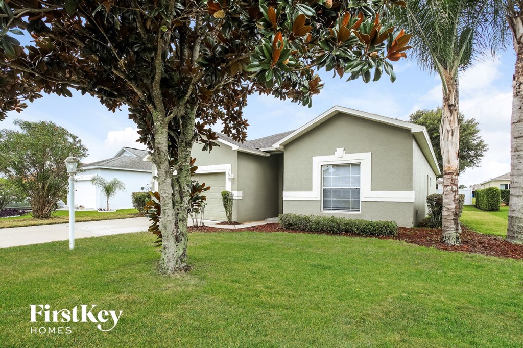 A house with a tree in front of it.