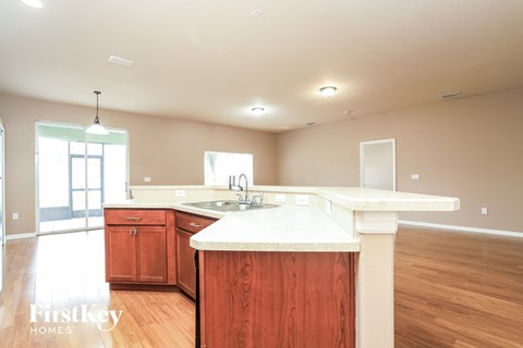A kitchen with wooden cabinets and a white countertop.