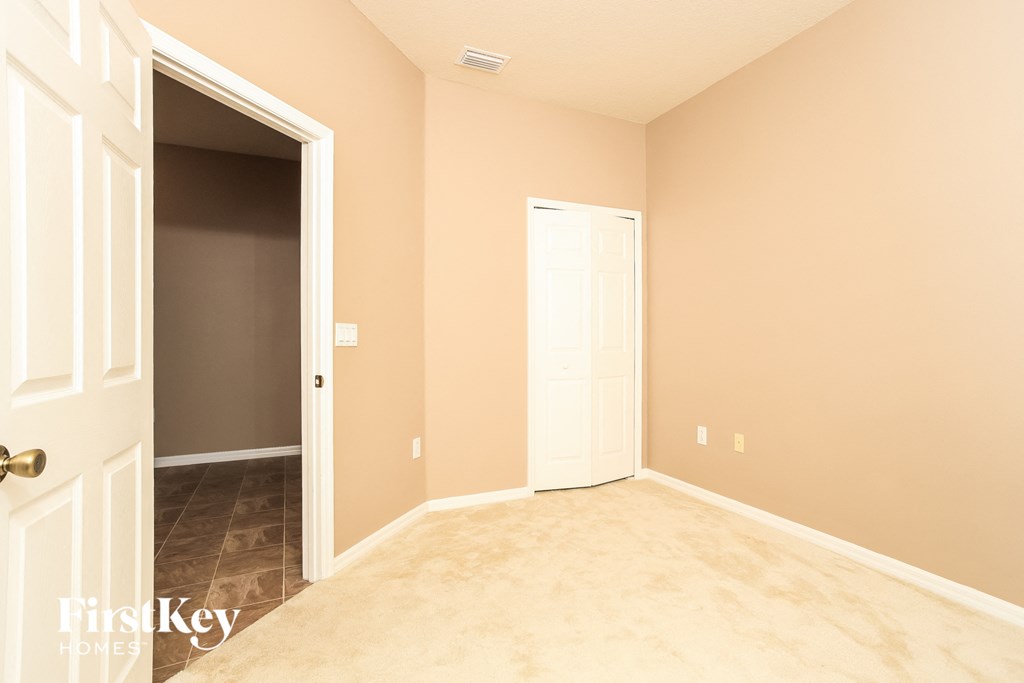 A room with a white door and a brown door.