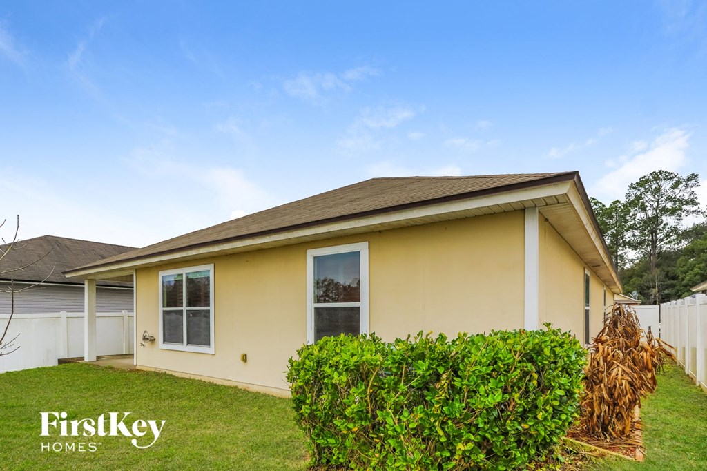 A house with a yellow exterior and a brown roof is for sale.