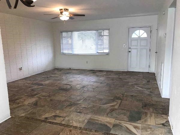 A room with a tiled floor and a ceiling fan.