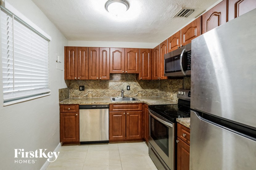 a kitchen with stainless steel appliances and wooden cabinets