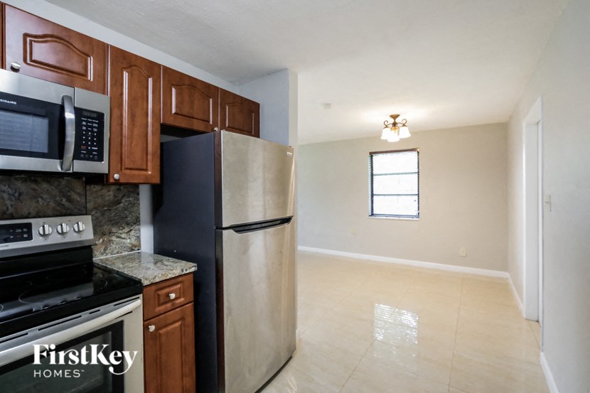 a kitchen with stainless steel appliances and wooden cabinets