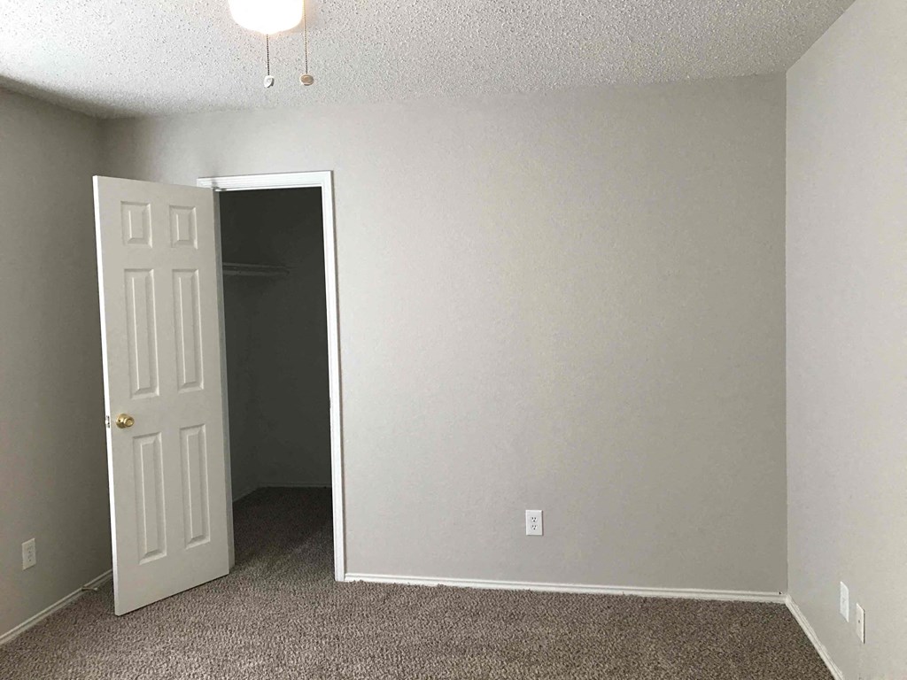 A room with a door and a carpet.