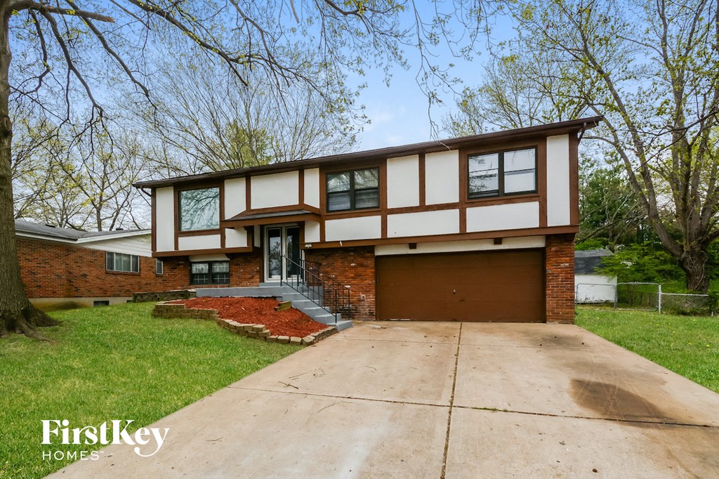 A house with a brown garage door is for sale.