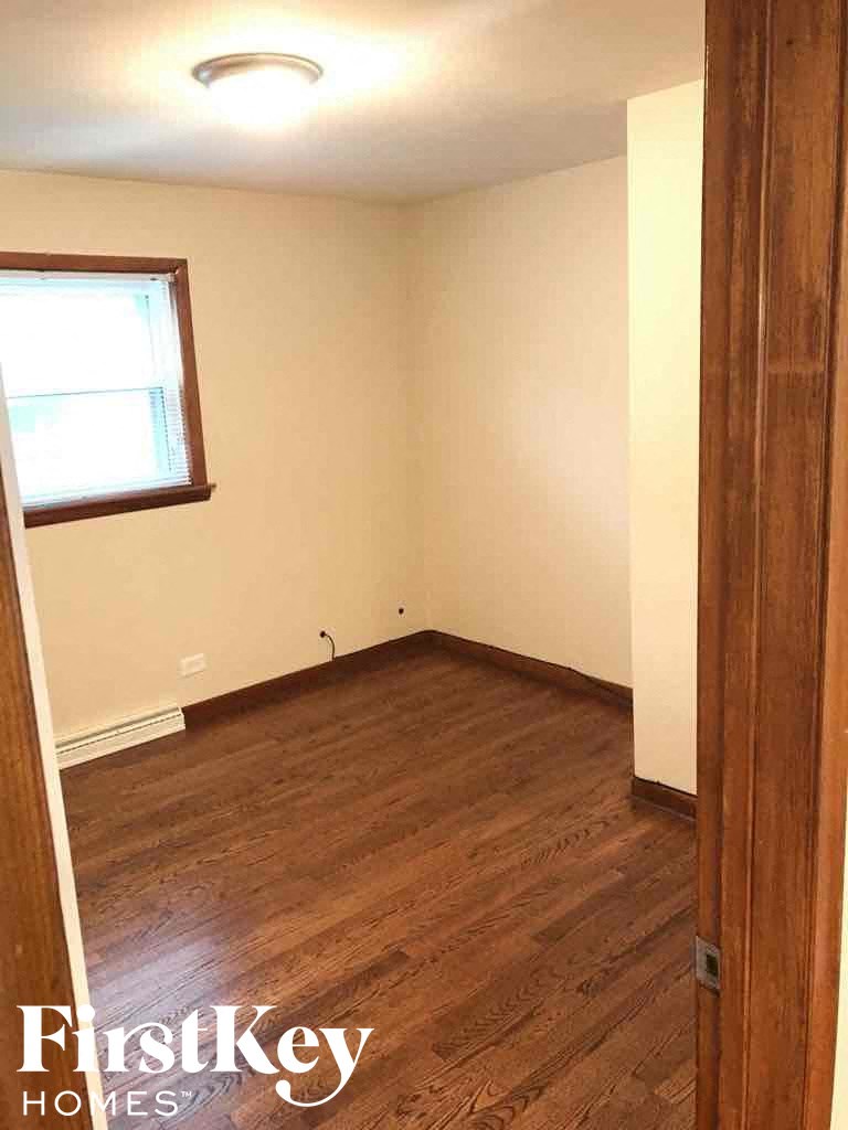 a empty room with wooden floors and a window