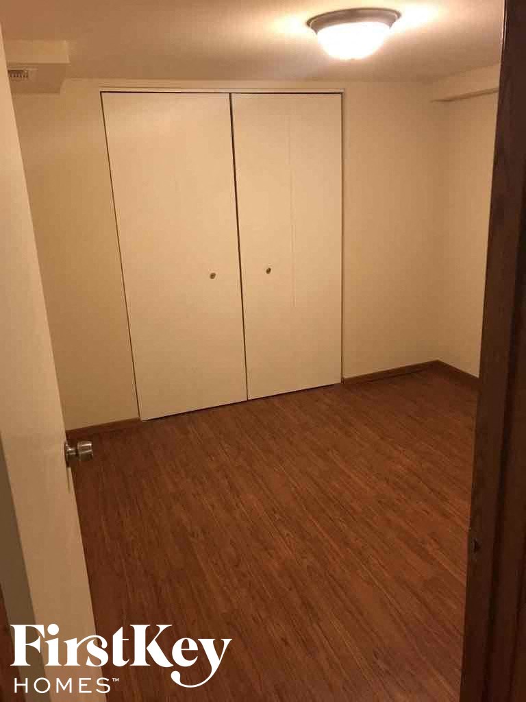 a room with white closets and a wooden floor