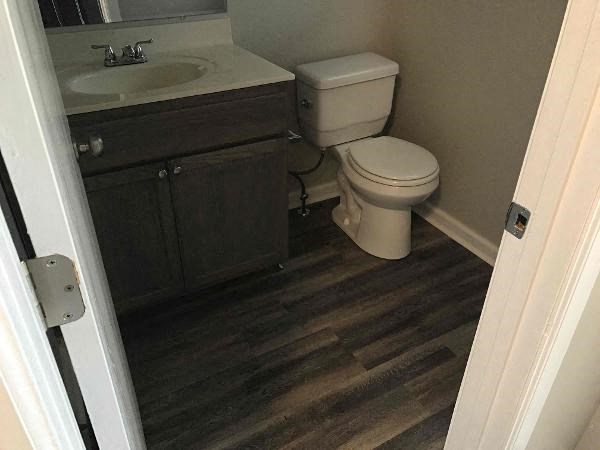 A bathroom with a toilet and sink.