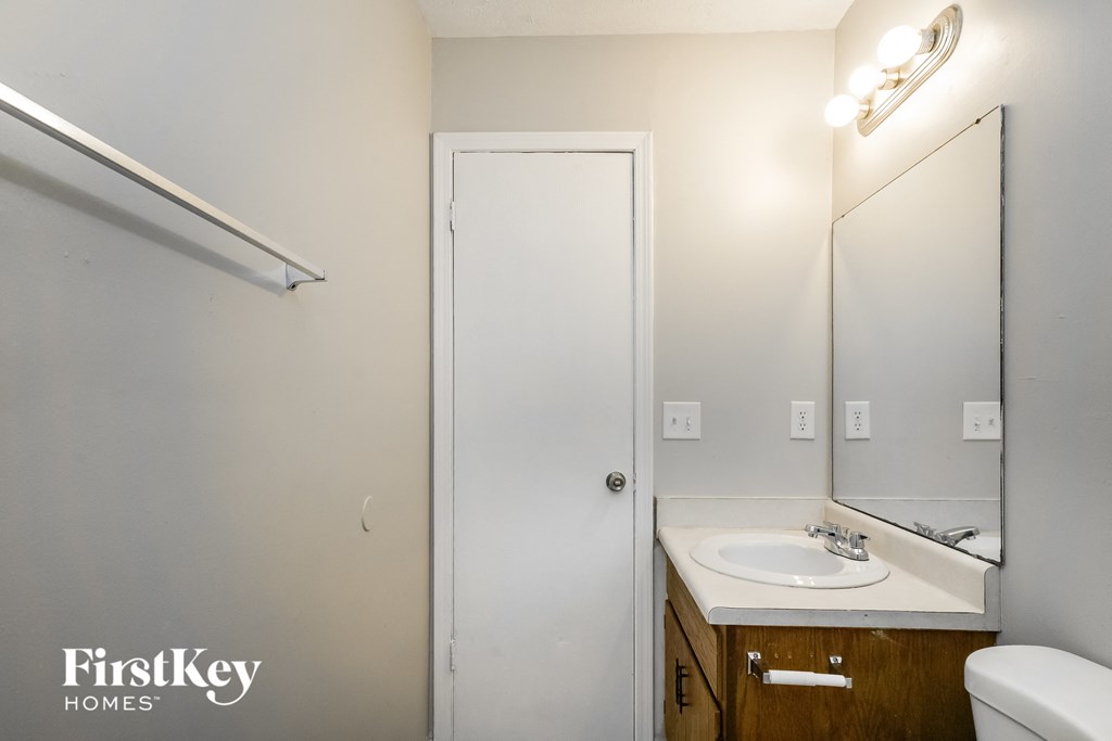 a small bathroom with a sink and a mirror