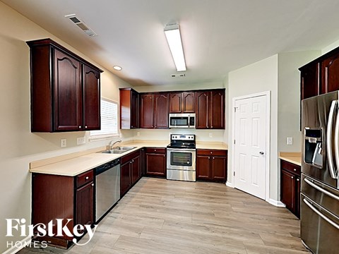 a kitchen with wooden cabinets and stainless steel appliances