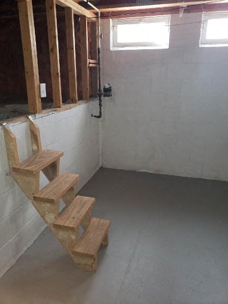 a staircase in a room with wooden steps on the floor
